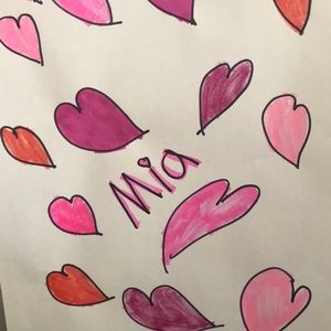 Hearts and the name is Mia hearts are pink red purple.